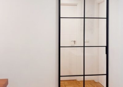 Puerta corredera colocada ente salón y zona de habitaciones, colocada en superficie sobre pared. Trabajo rápido y sin obras